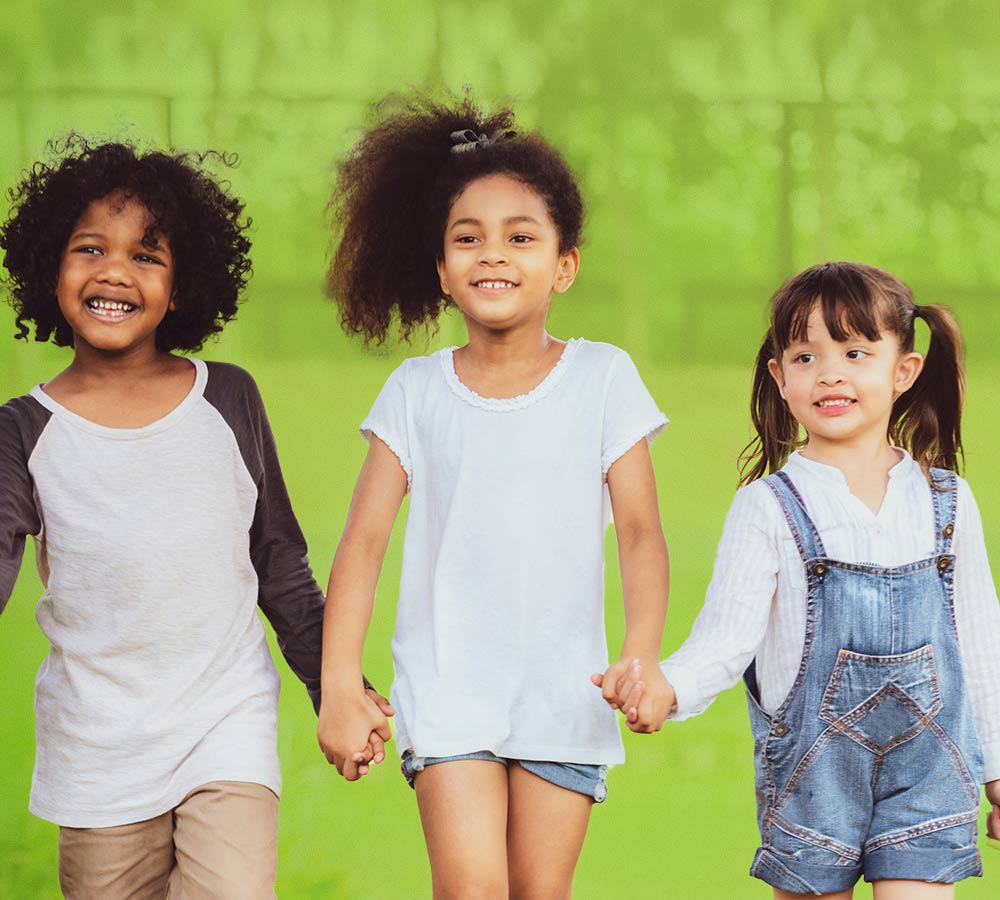 young-children-holding-hands-standing-strong-smiling-together