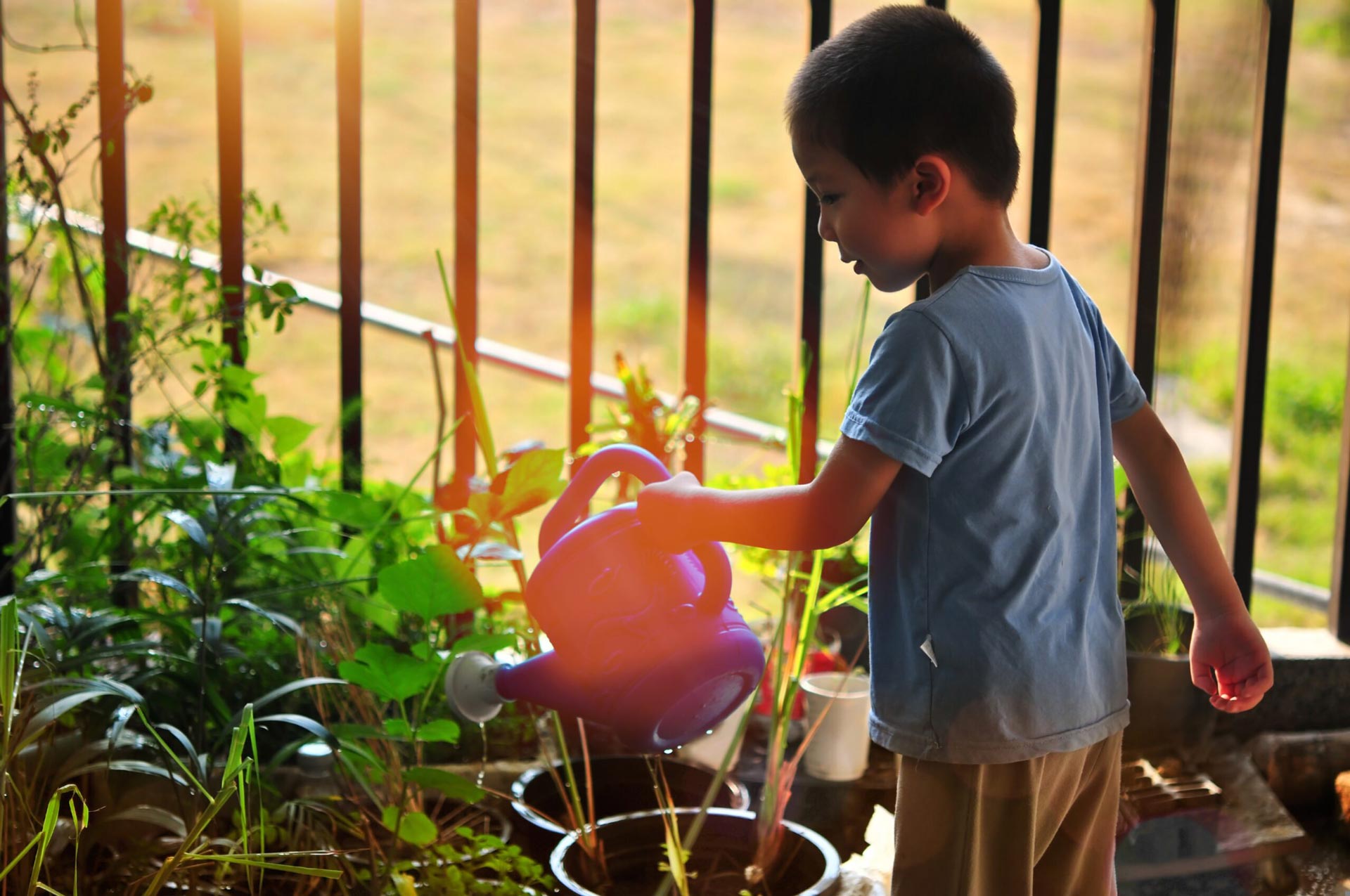 child-watering-garden